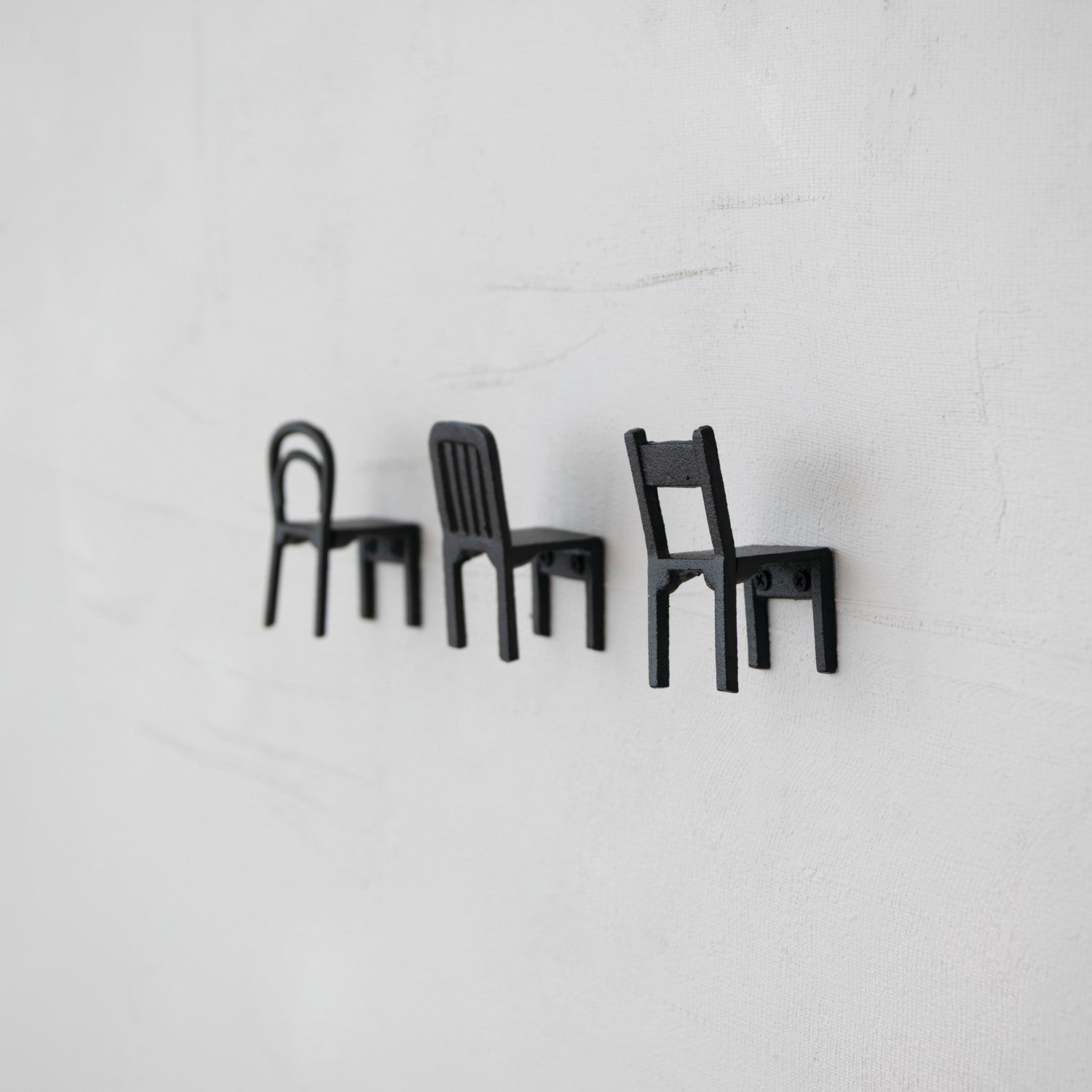 Black cast iron chair shaped wall hooks in Bentwood, Slat Back and Ladder Back styles
