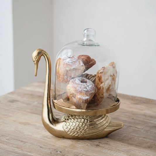 Antique gold swan serving stand with clear glass cloche dome for displaying pastries and treats
