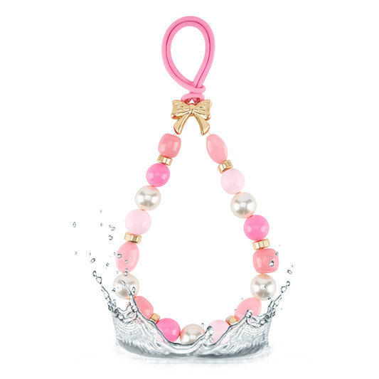 Pink beaded bag charm with pearl accents gold bow charm and pink silicone loop