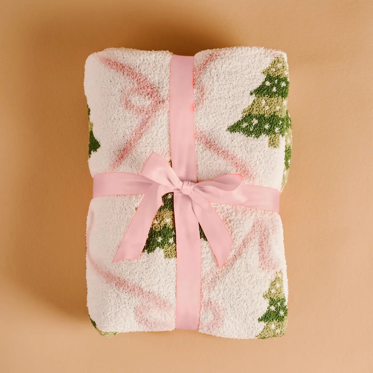 Pink bow Christmas tree blanket folded and wrapped with pink ribbon
