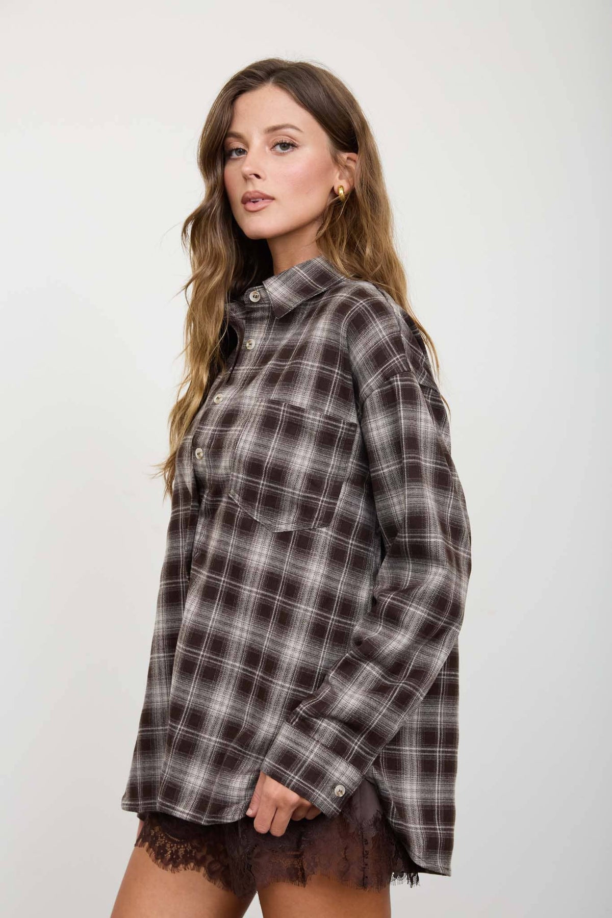 Side view of women’s brown plaid shirt with dropped shoulders