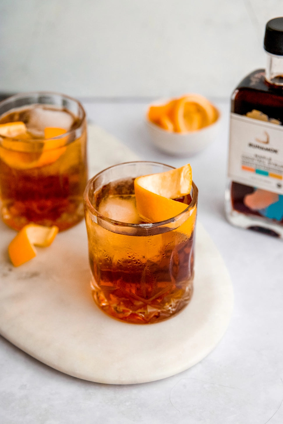 Old Fashioned cocktails with orange peel made with Runamok maple cocktail mixer