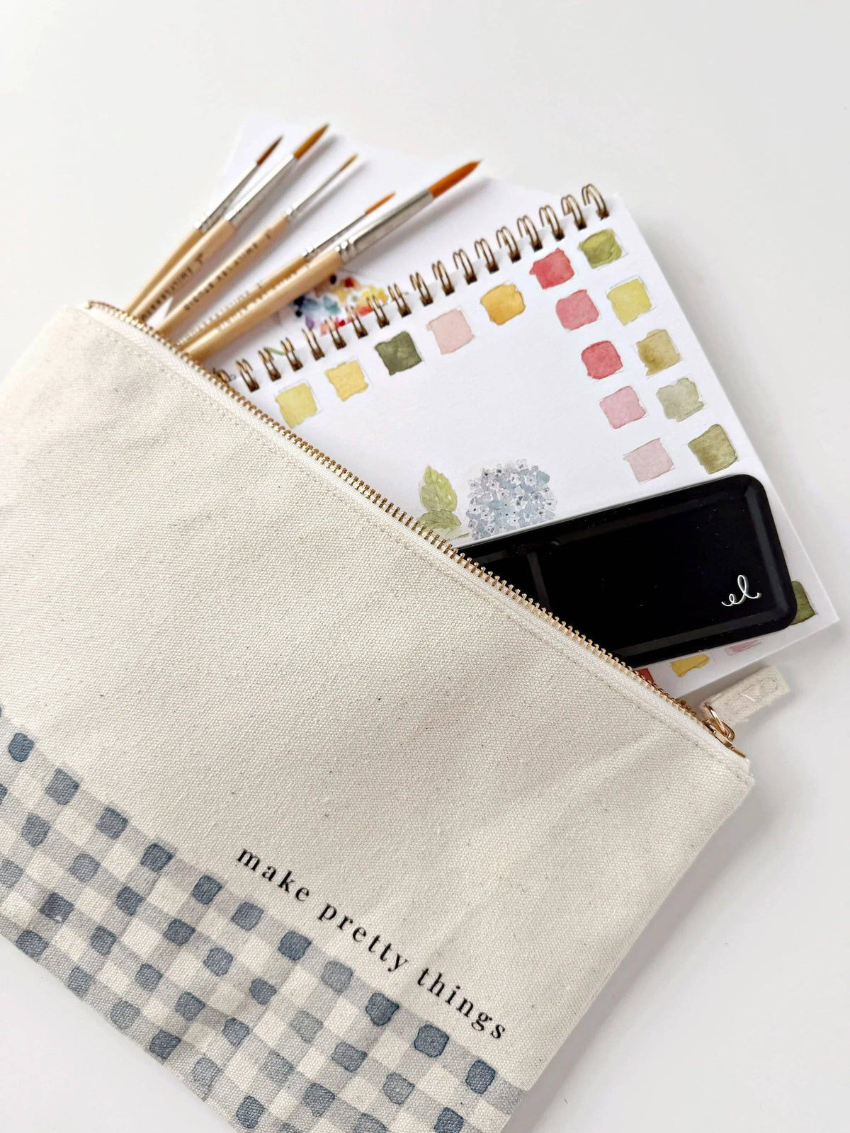 Cream gingham canvas art supply pouch with watercolor paintbrushes