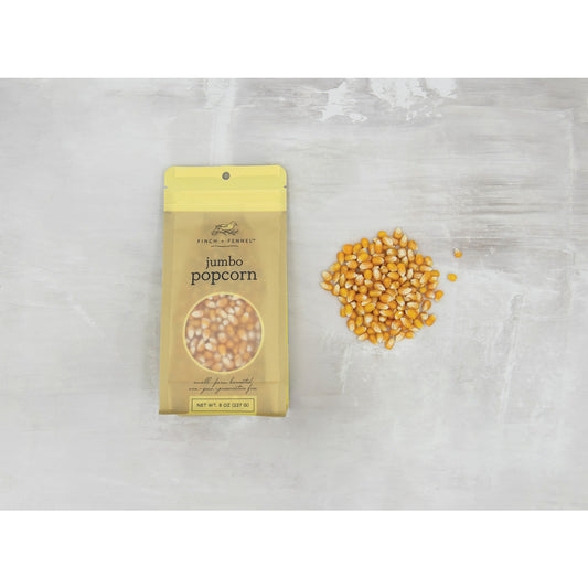 Finch + Fennel 8 oz Jumbo Popcorn Kernels in yellow resealable bag with loose popcorn kernels