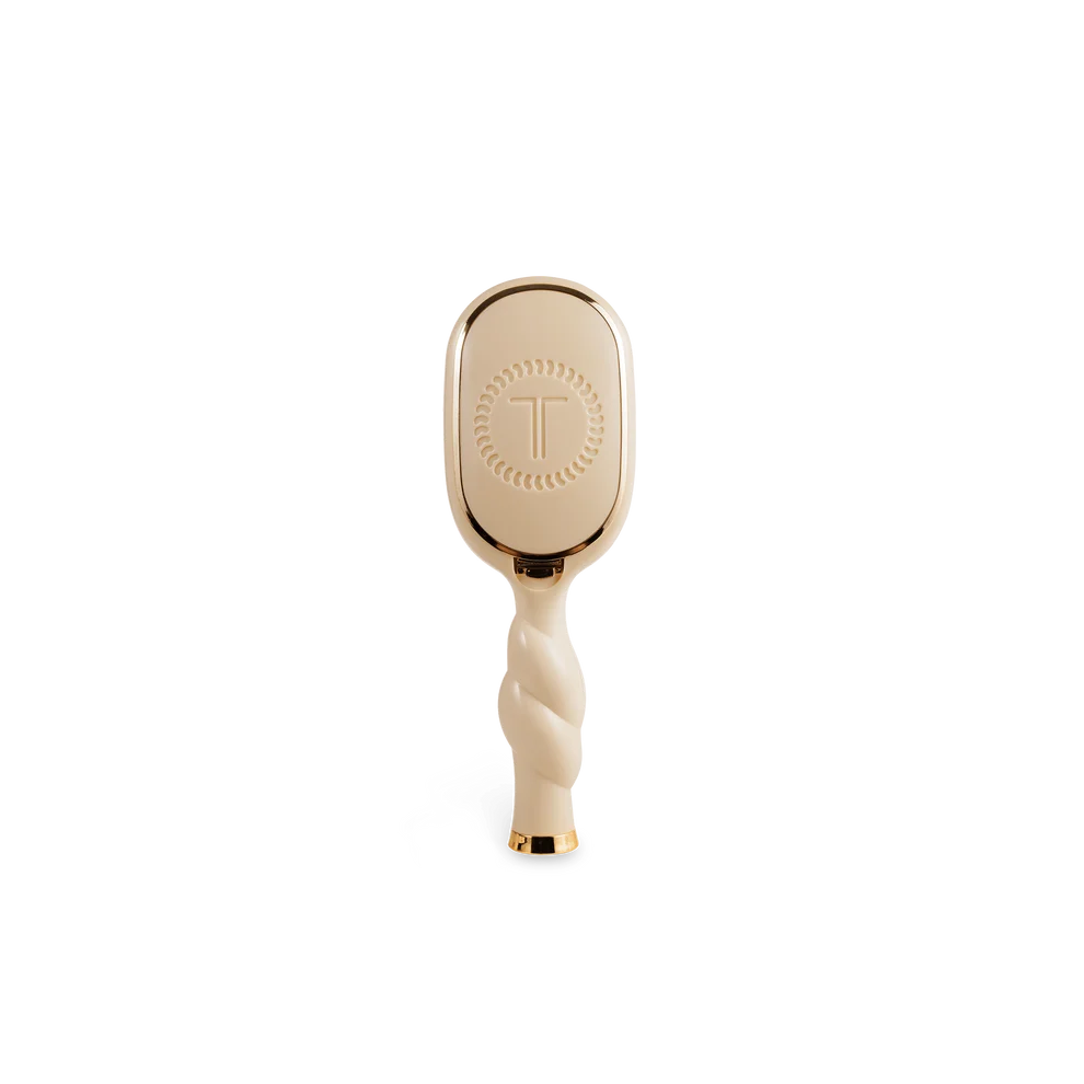 Back of TELETIES Mini Boar Bristle Hair Brush in Tan with built-in storage compartment