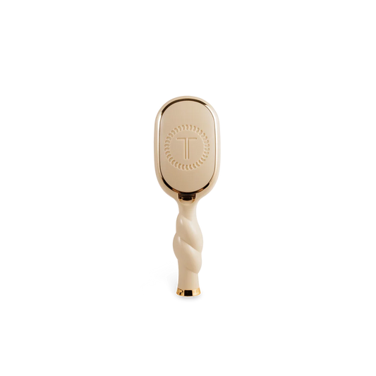Back of TELETIES Mini Boar Bristle Hair Brush in Tan with built-in storage compartment
