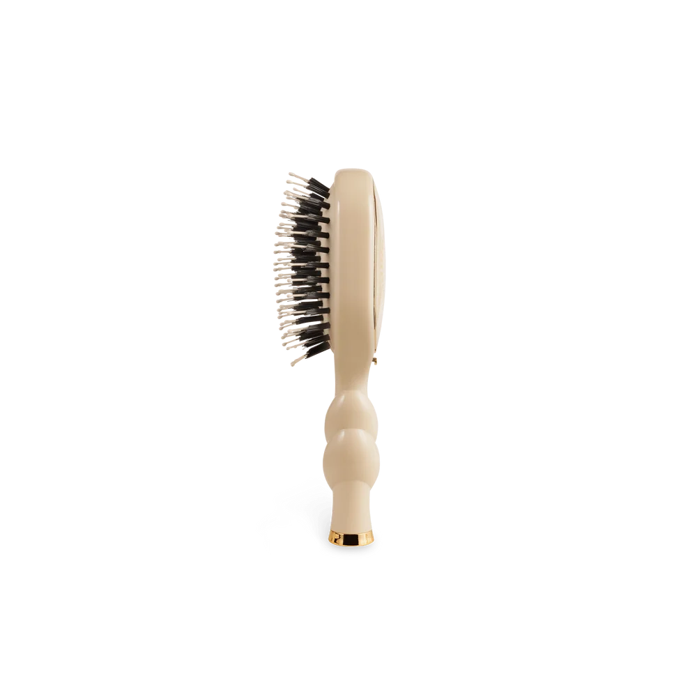 Side view of TELETIES Mini Boar Bristle Hair Brush in Tan showing natural boar bristles
