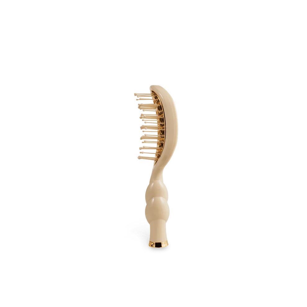 Side view of TELETIES Mini Vented Hair Brush in Tan with anti-static bristles and gold accents