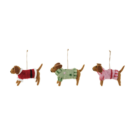 Three wool felt dachshund Christmas ornaments in red green and pink sweaters